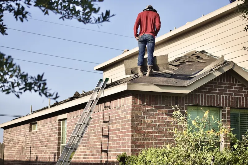 Professional roofer working on a residential roof in Senoia